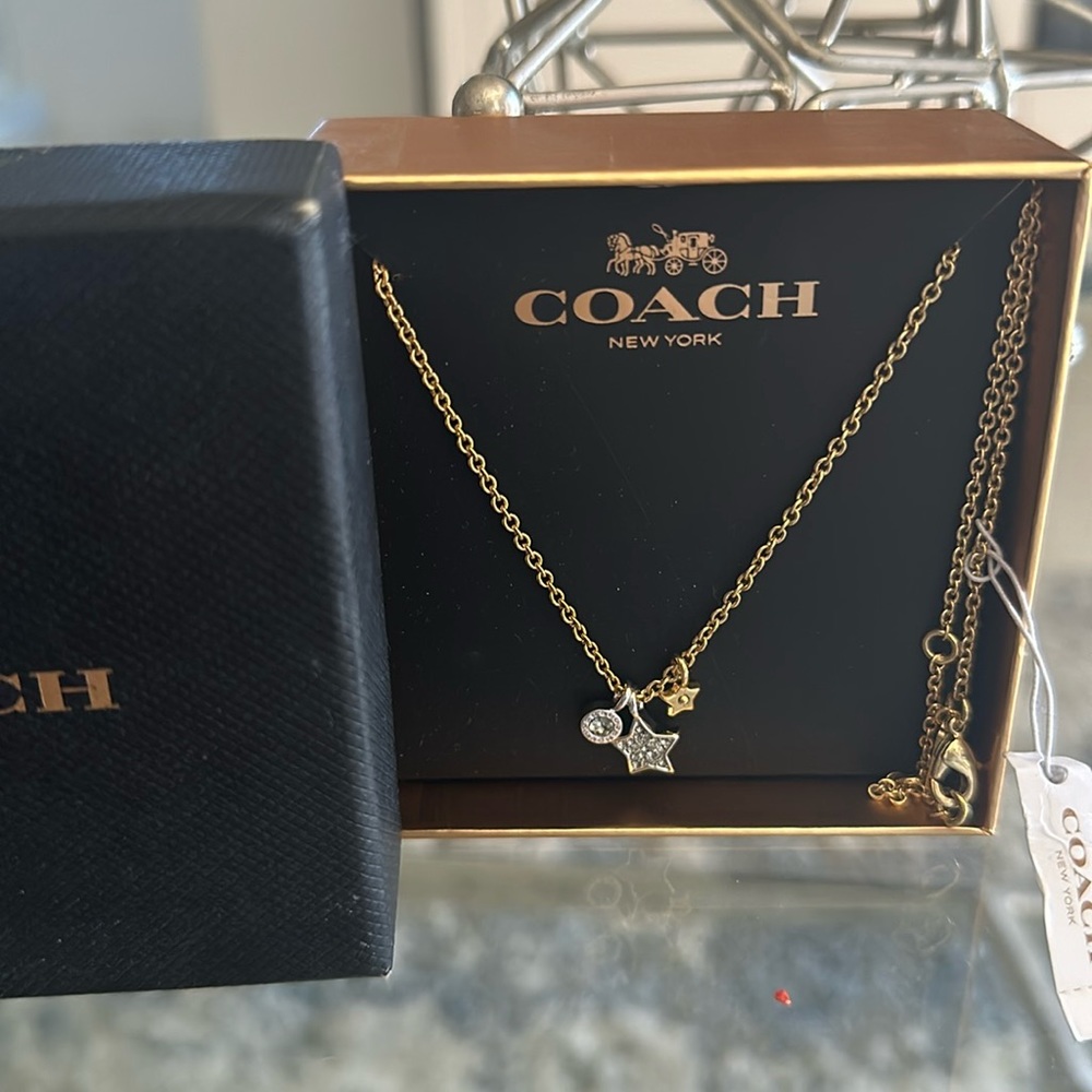 Coach necklace that contains two stars